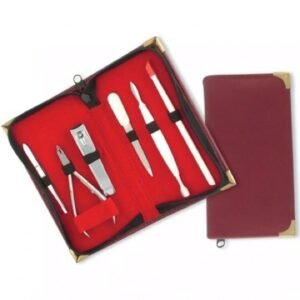 Premium manicure and pedicure grooming kit with stainless steel tools in a red leather case with gold corner accents.